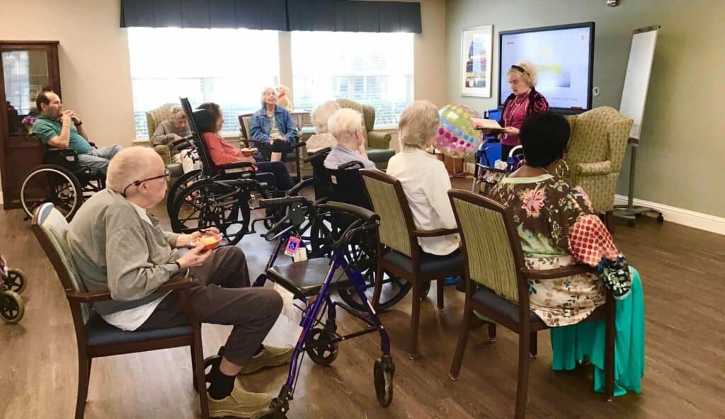 Parmer Woods at North Austin | Seniors sitting quietly at a poetry reading