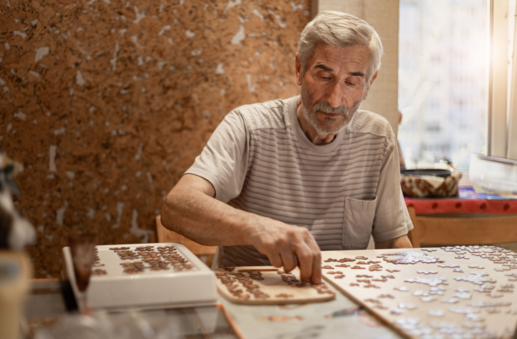 Pegasus Landing of Crystal Falls in Leander | Senior man doing a jigsaw puzzle