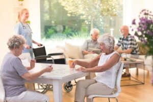 Pegasus Landing of Katy | A group of seniors playing cards together in their assisted living community.