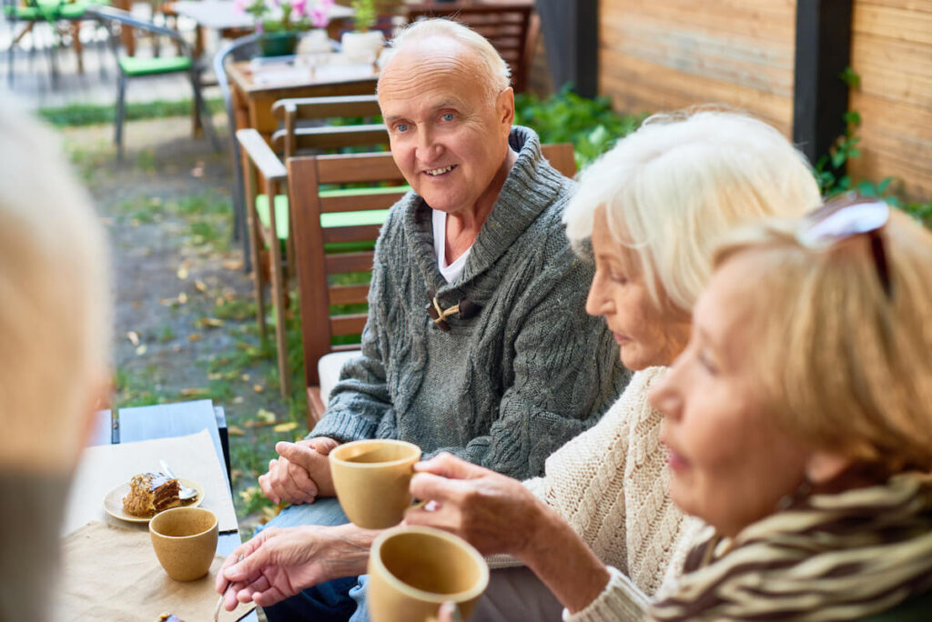 The Courtyards at Mountain View | Seniors socializing while having coffee