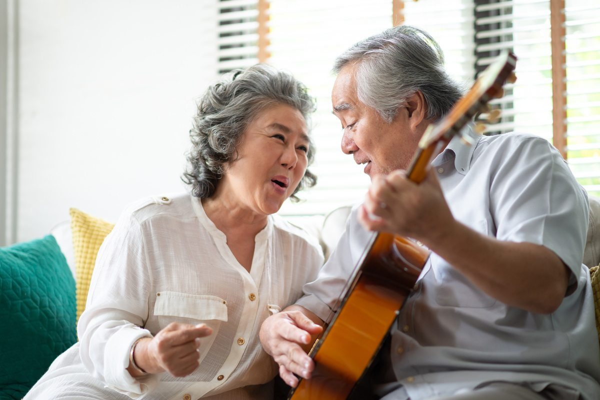 Laketown Village | Senior couple playing the guitar and singing