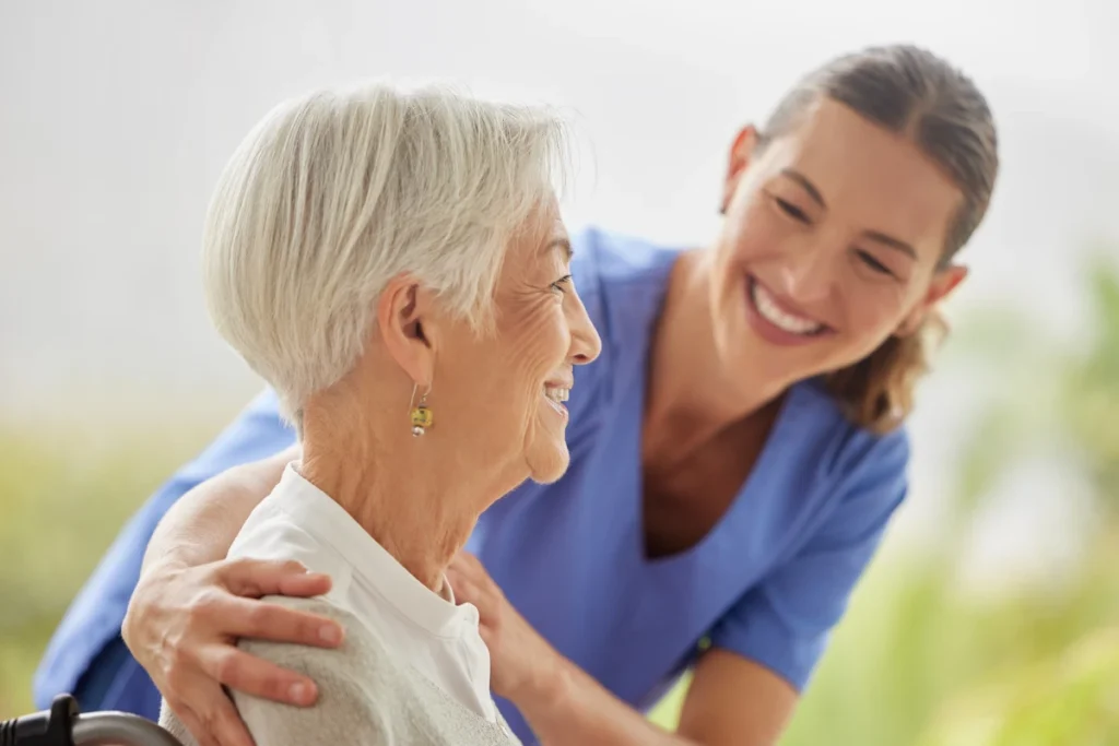 Senior resident laughing with caregiver