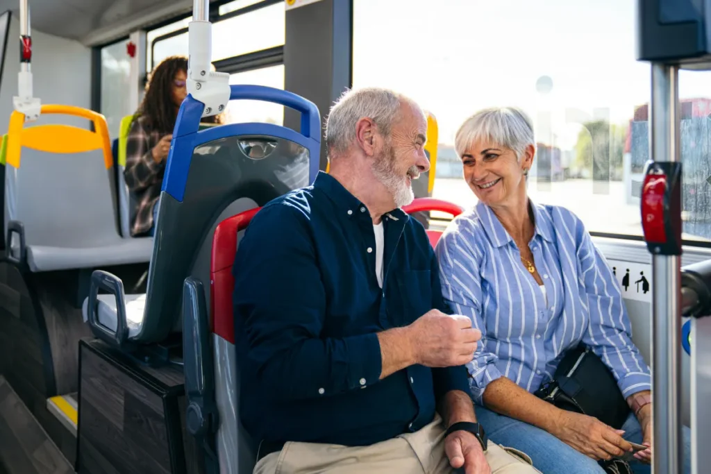 A senior couple riding a bus