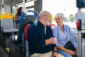 A senior couple riding a bus
