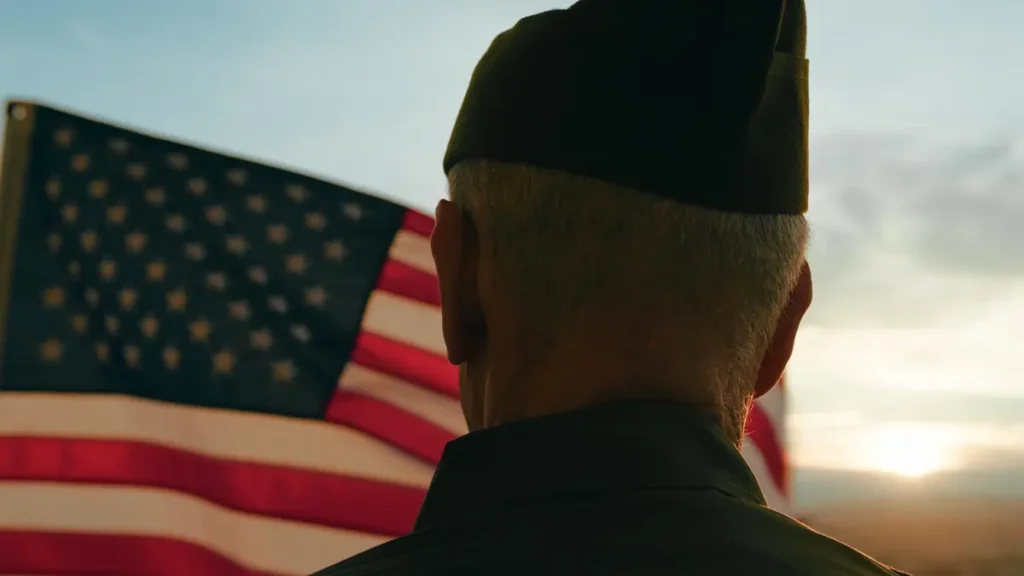 Elderly Man Stand Against American Flag For Veterans Day Holiday.