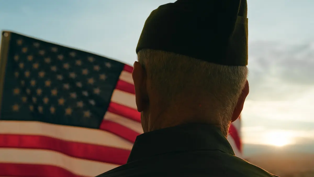 Elderly Man Stand Against American Flag For Veterans Day Holiday.