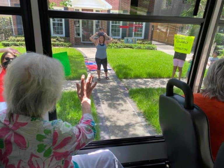 Pegasus Landing of Tanglewood | Resident waving to family from bus window