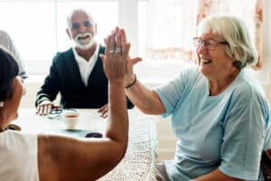 Pegasus Landing of Tanglewood | Happy seniors high-fiving each other