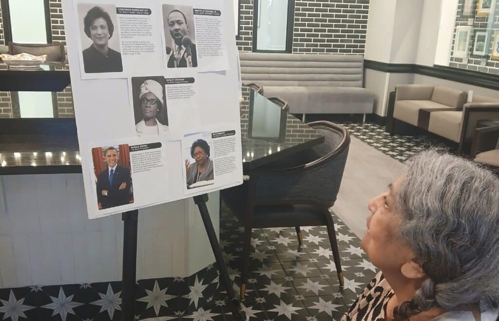 Pegasus Senior Living | Resident looking at a community display