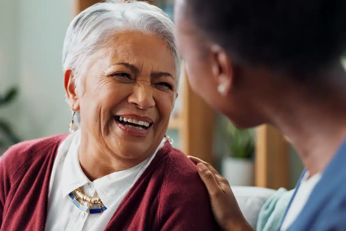 Home Caregiver and senior woman chatting