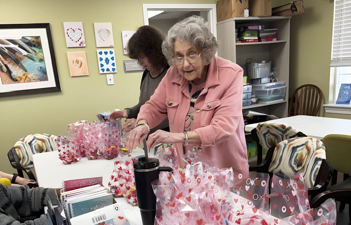 Pegasus Senior Living | Several enthusiastic ladies work on making gift bags to show appreciation for the caregivers of Ridgeland Place.