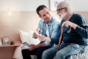 Ridgeland Place | Father and adult son looking at old photos