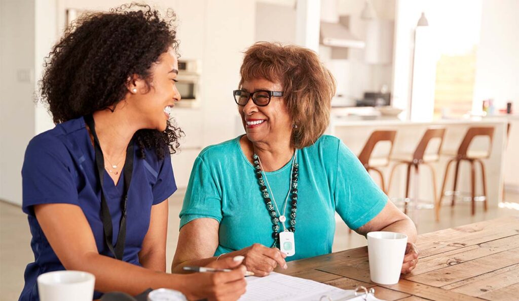 Ridgeland Place | Mississippi senior care - senior woman talking to her caregiver and looking at paperwok