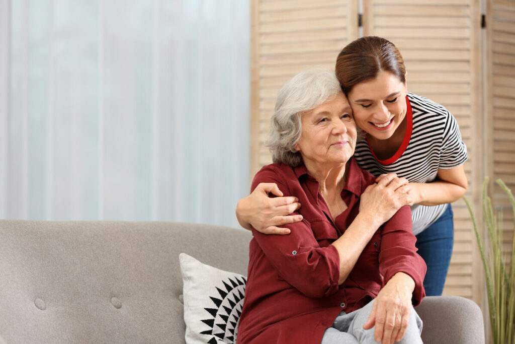 Pegasus Senior Living | Senior woman getting a hug from her caregiver