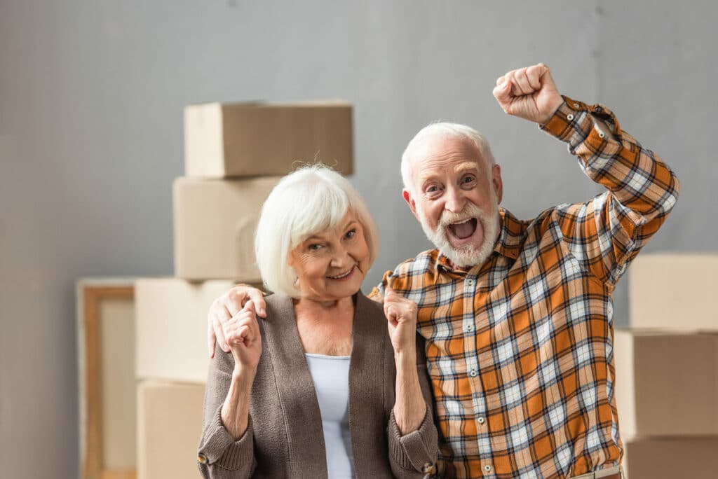 Pegasus Senior Living | Happy Seniors standing next to moving boxes