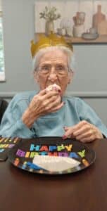 South Hill Village | Senior eating cake on her birthday