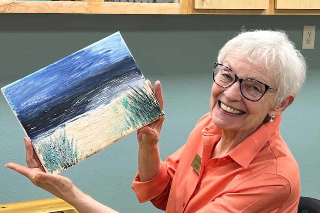 South Hill Village | Senior community resident showing her painting