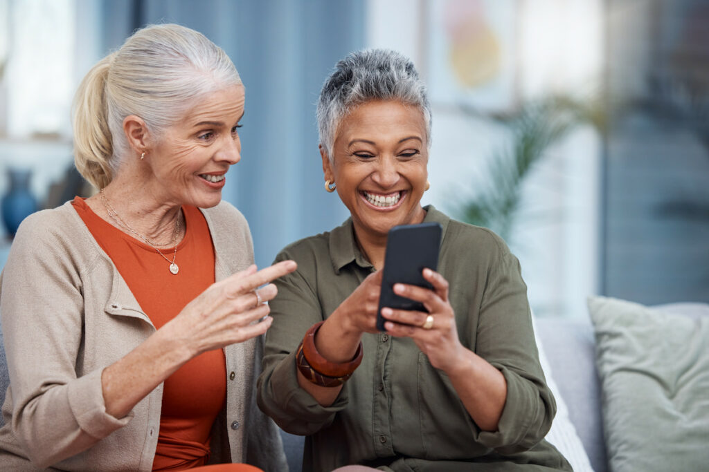 Sterling Court at Roseville | Senior women looking at their phones and laughing