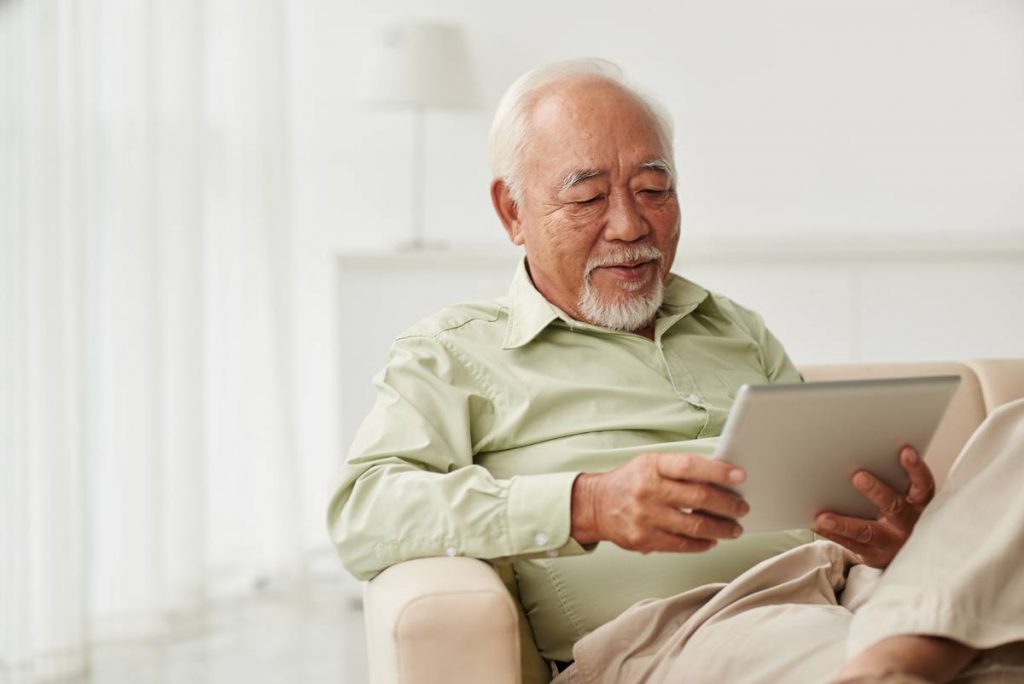 The Chateau at Gardnerville | Happy senior man using tablet