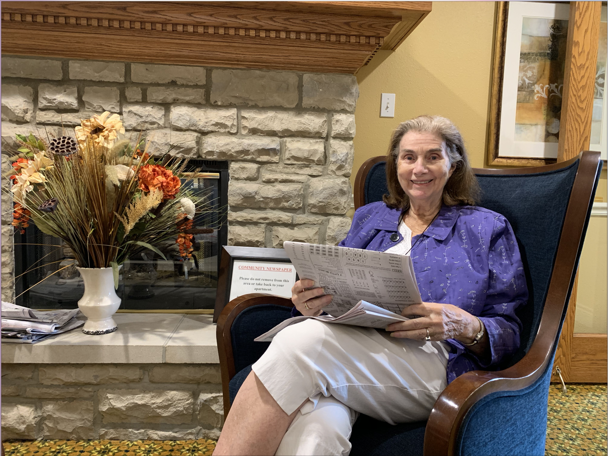 Pegasus Senior Living | Resident reading newspaper