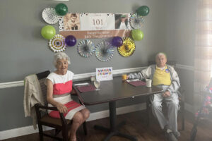 The Chateau at Gardnerville | Senior man, Richard Bell, seated at table with 101st birthday celebration decorations