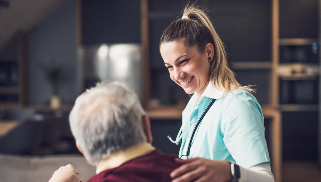 The Courtyards at Mountain View | Azheimers care denver, CO - Caregiver assisting a senior man