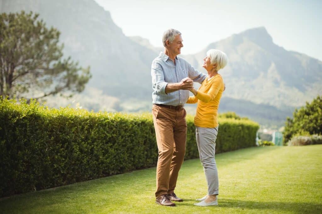 Pegasus Senior Living | Senior couple dancing outside with mountain views