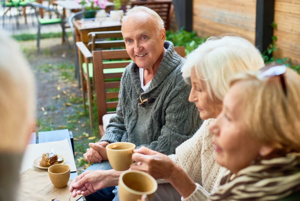 The Courtyards at Mountain View | Seniors socializing while having coffee