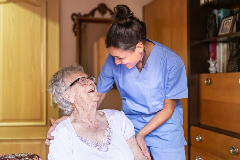 The Courtyards at Mountain View | Happy senior and caregiver smiling