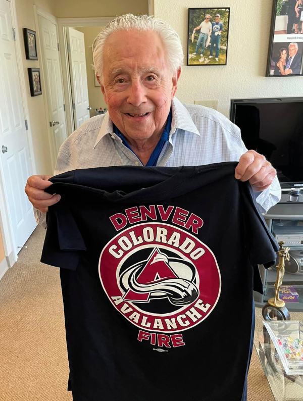 The Courtyards at Mountain View | Senior resident holding Colorado shirt