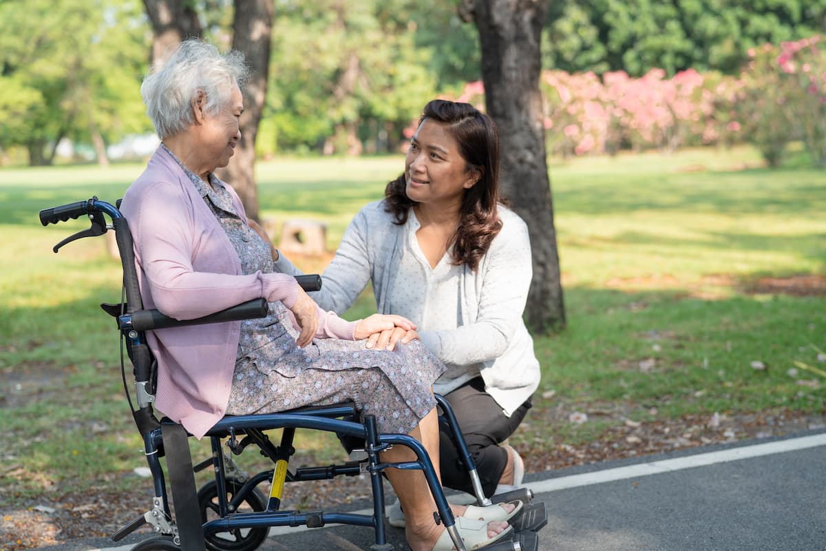 The Farrington at Tanglewood | Dementia caregiver Houston - senior woman in wheelchair with caregiver