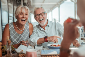 Pegasus Senior Living | Happy couple laughing at the dinner table