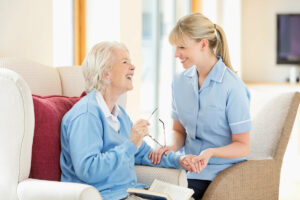 The Gardens at Marysville | Senior woman and her caregiver laughing together