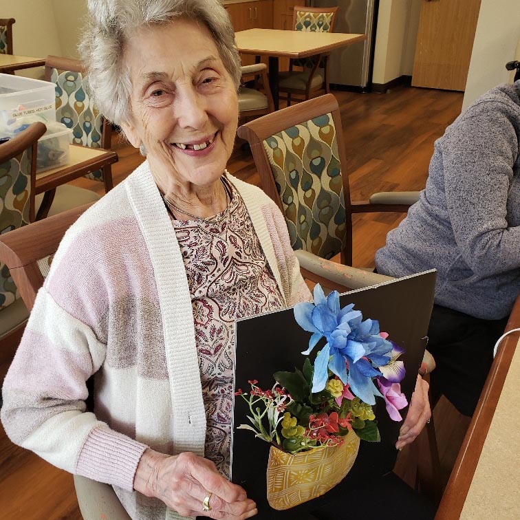 The Gardens at Marysville | Assisted living resident holding flowerpot art