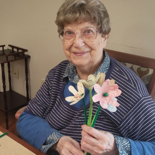 The Gardens at Marysville | Assisted living resident holding flower craft