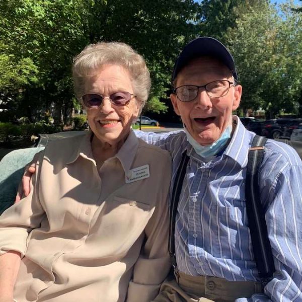 The Gardens at Marysville | Two residents sitting outside smiling and enjoying the outdoors