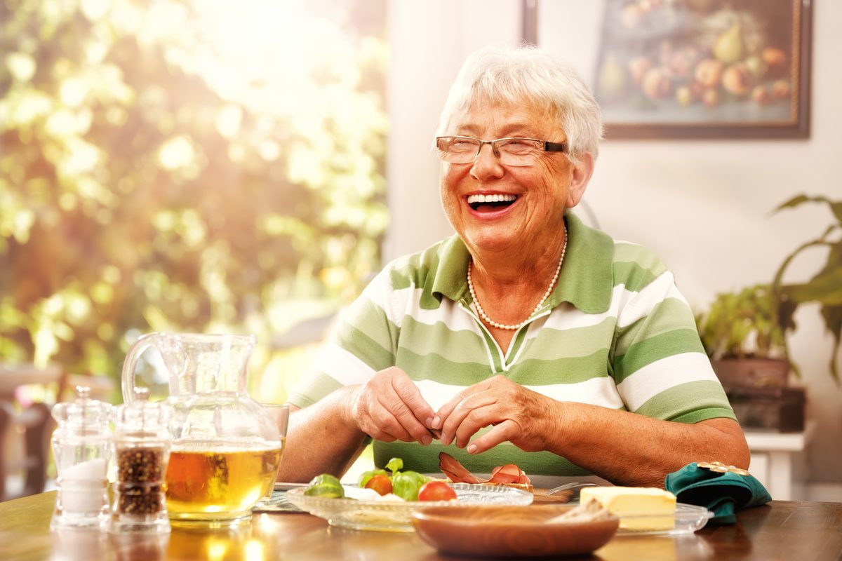 The Havens at Antelope Valley | Happy senior woman eating breakfast