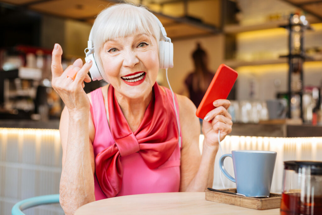 The Landing at Queensbury | Cheerful positive woman enjoying rock music