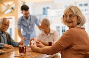 The Legacy at Crystal Falls in Leander | Seniors drinking tea and playing cards