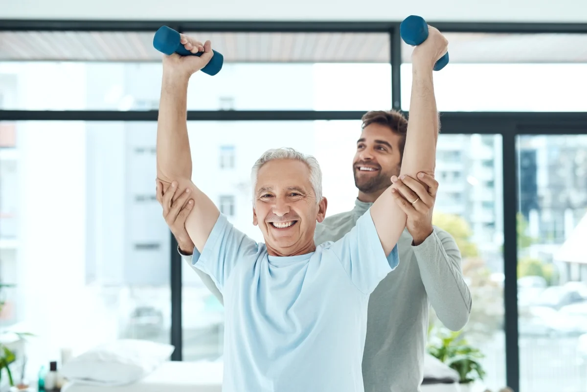 Senior exercising with help from a physical therapist