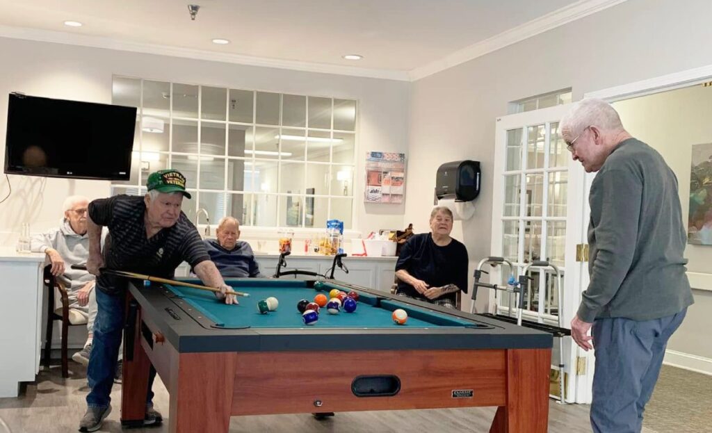 Pegasus Senior Living | Residents playing pool
