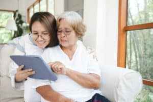 The Rivers at Puyallup | Senior woman and her daughter looking at an ipad