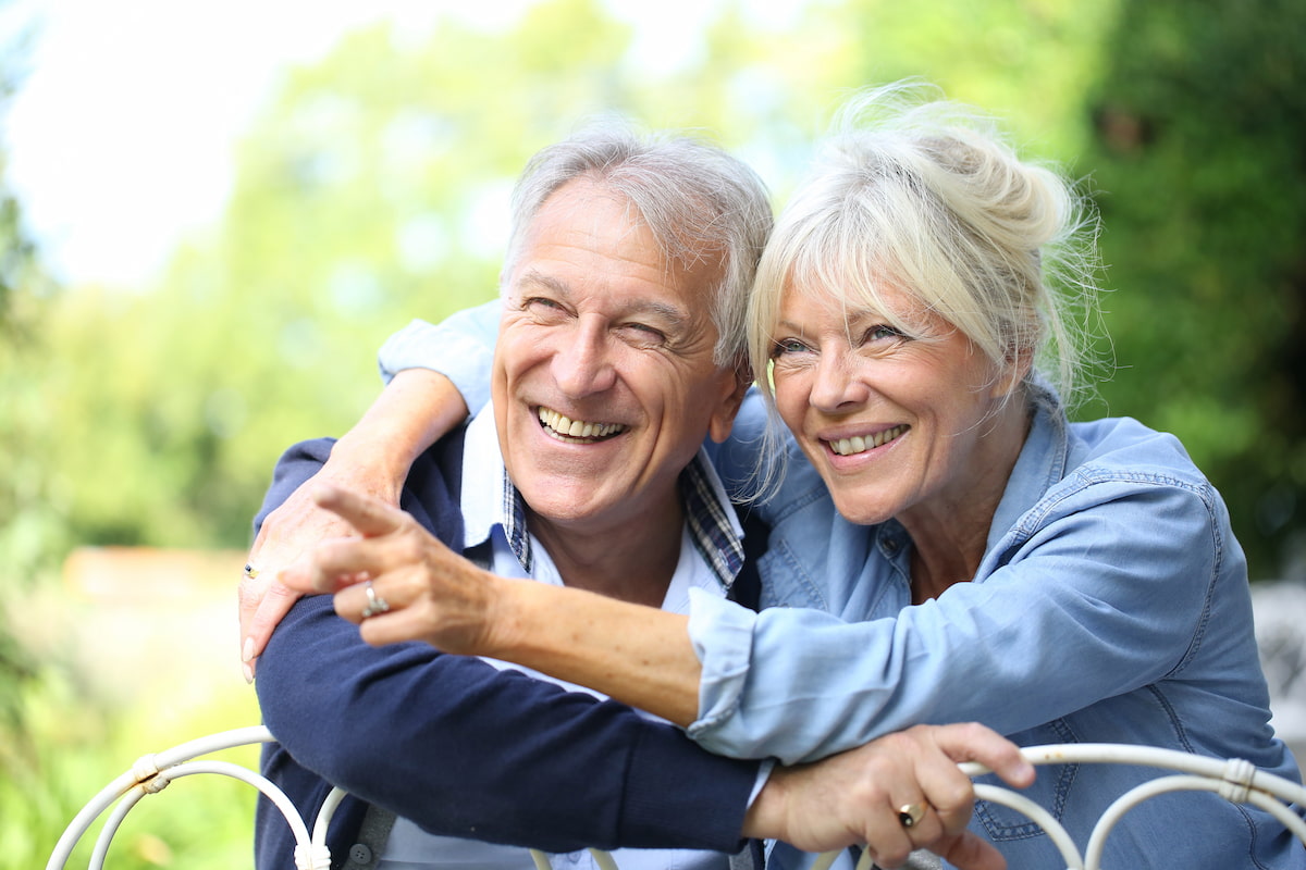 The Seasons of Reno | Senior couple leaning on fence and smiling