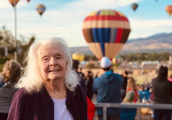 The Seasons of Reno | Resident in front of air balloons