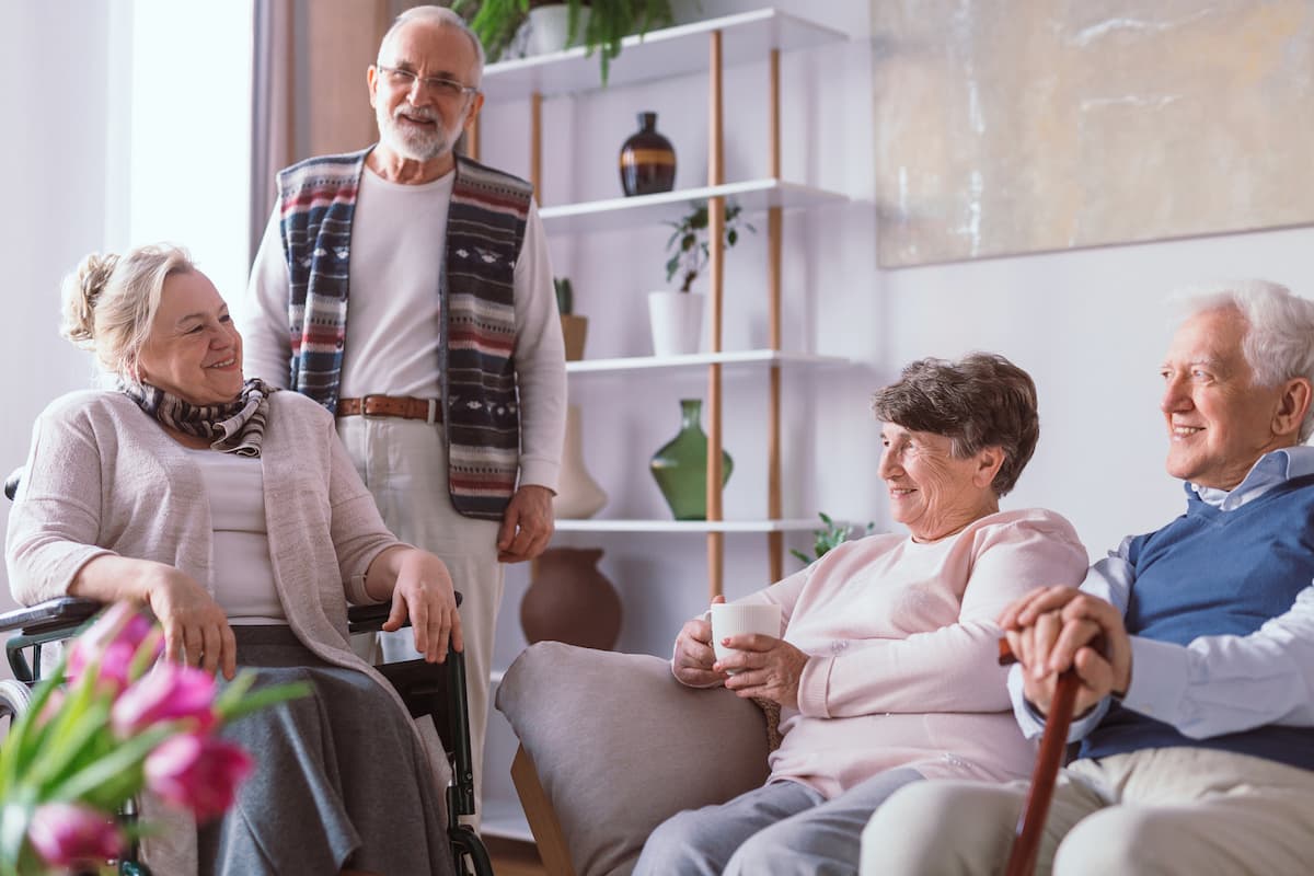 Village at Rancho Solano | Fairfield assisted living - group of smiling seniors socializing in common area together