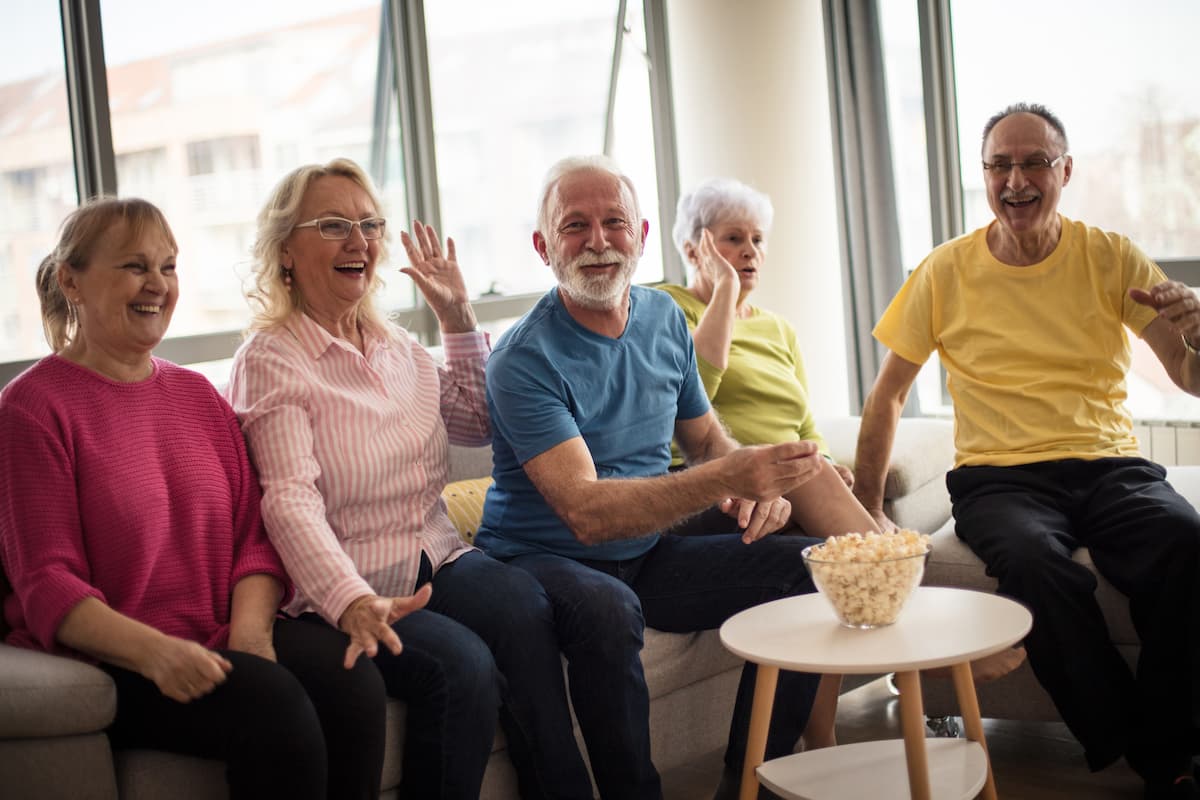 The Village at Rancho Solano | Group of seniors watching movie together and eating popcorn - assisted living Richmond, CA