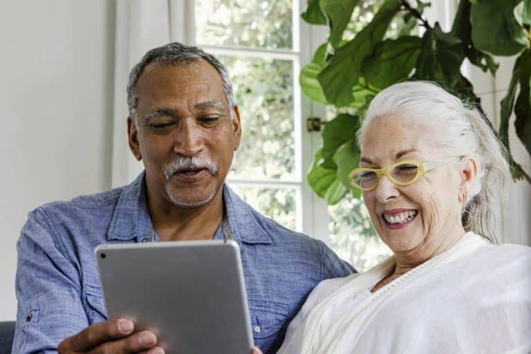 The Village at Rancho Solano | Happy seniors using tablet