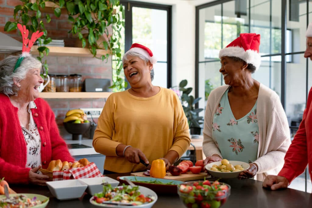 Pegasus Senior Living | Group of happy seniors cooking for the holidays