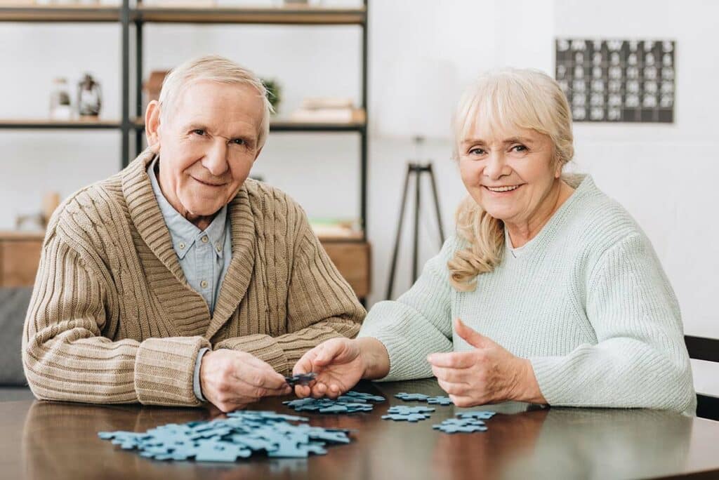 The Village at Rancho Solano | Senior couple playing with puzzles