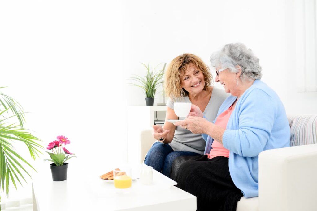 Pegasus Senior Living | Senior woman and caregiver eating breakfast together